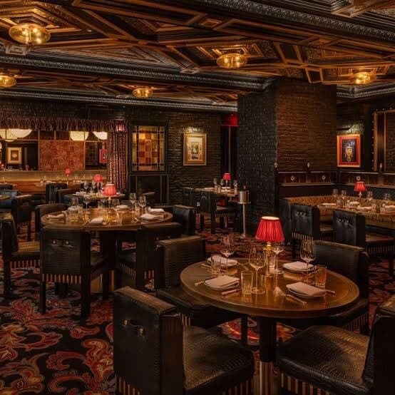 The dining room at Ambassadors Club House in New York, with dark timber, patterned carpet and red table lamps.